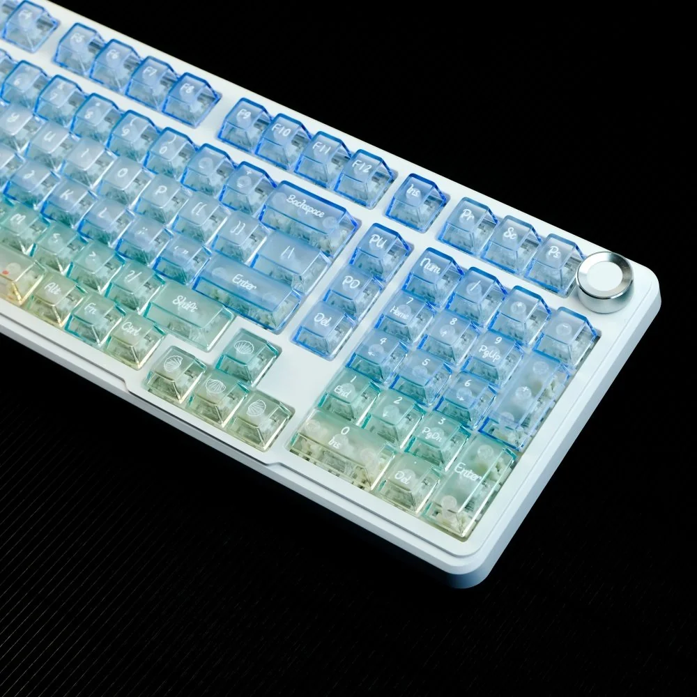 Frosted PC gradient keycaps set revealing their blue-white translucent blend. The unique frosted texture diffuses light, creating a serene ocean aesthetic.