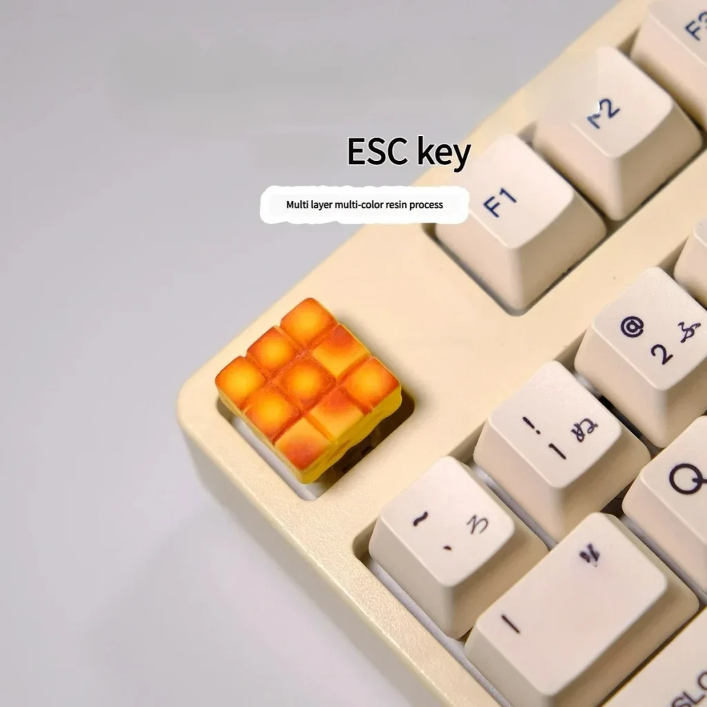 A whimsical handcrafted 3D dessert-themed artisan keycap showcasing a miniature grid cake design with vibrant, intricate details.