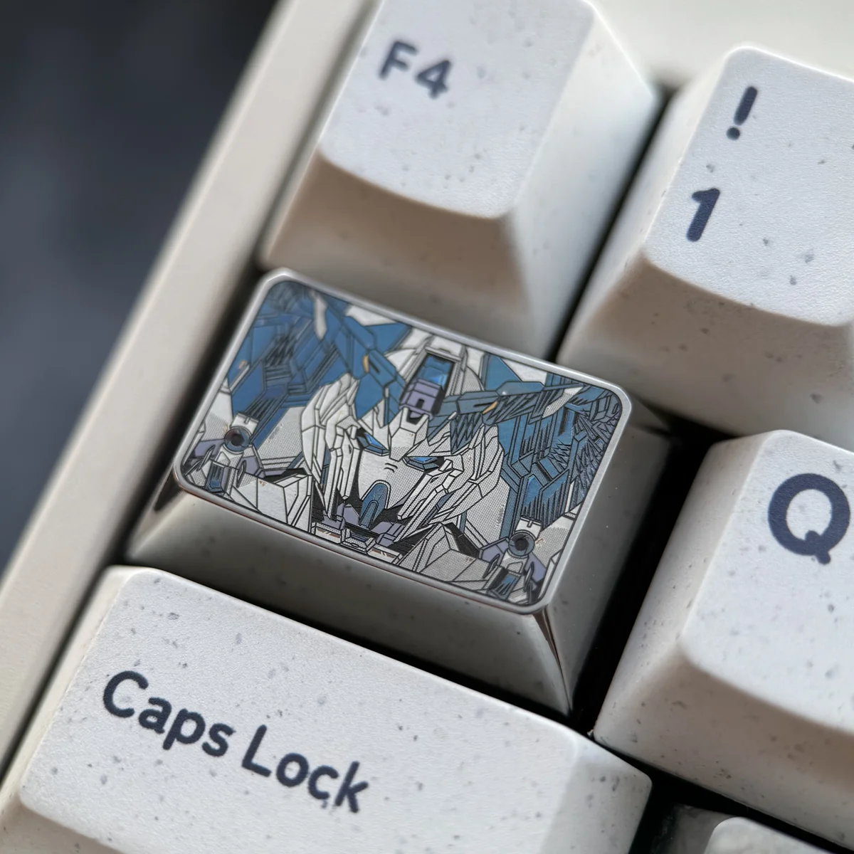 Gundam Titanium Keycap, a tab key, showcasing its iconic mecha design and futuristic metallic finish from various angles.