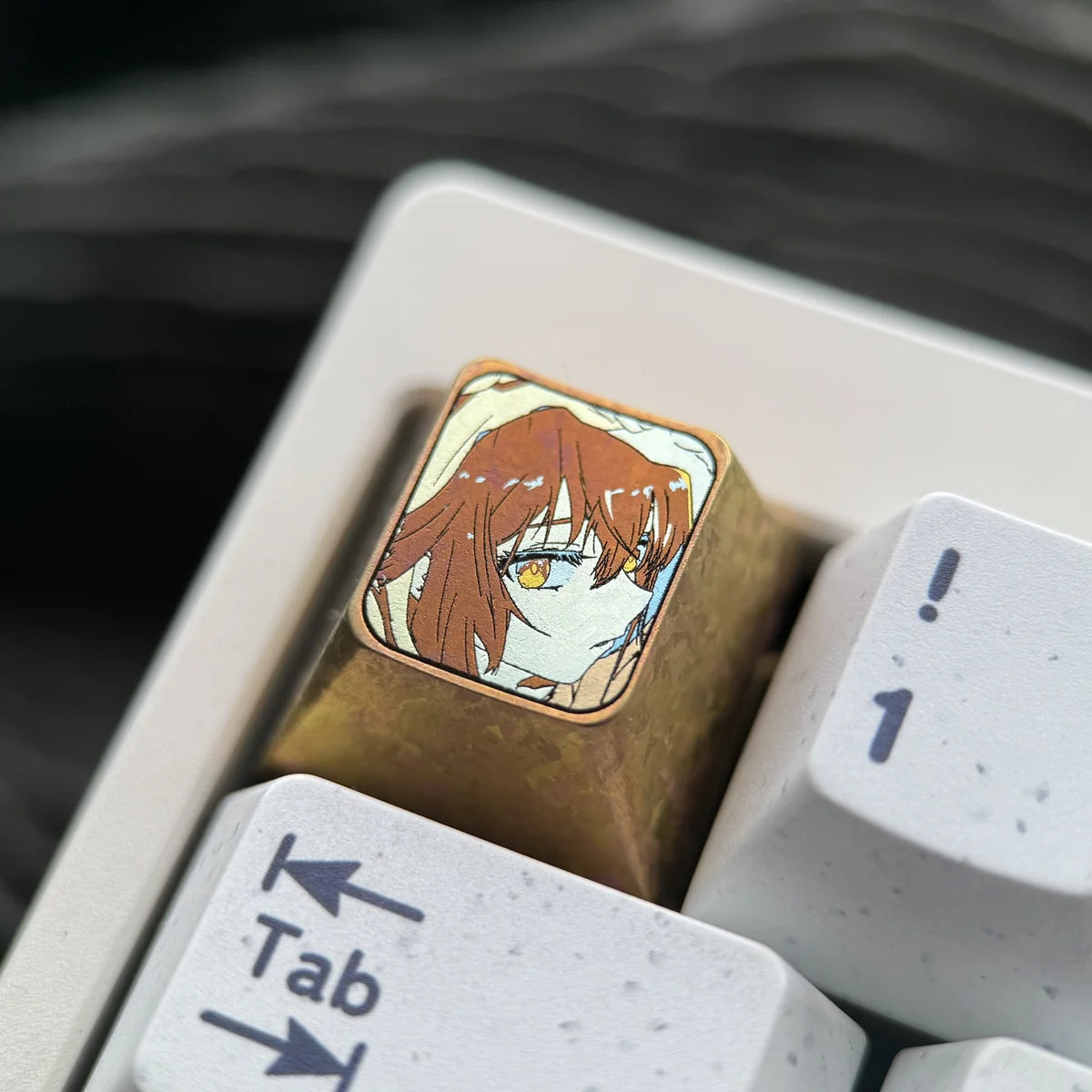 Ultra close-up of the Haibara Ai character on a titanium keyboard cap, revealing the precision etching and metallic sheen.