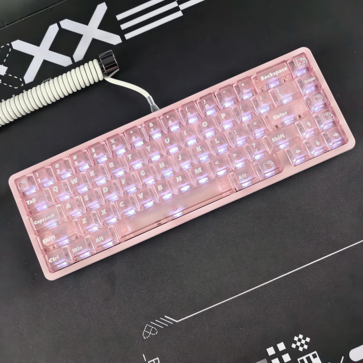 Detailed gallery images of the iconic Hello Kitty frosted pink keycap set, highlighting its whimsical character design and captivating backlit glow from multiple angles.