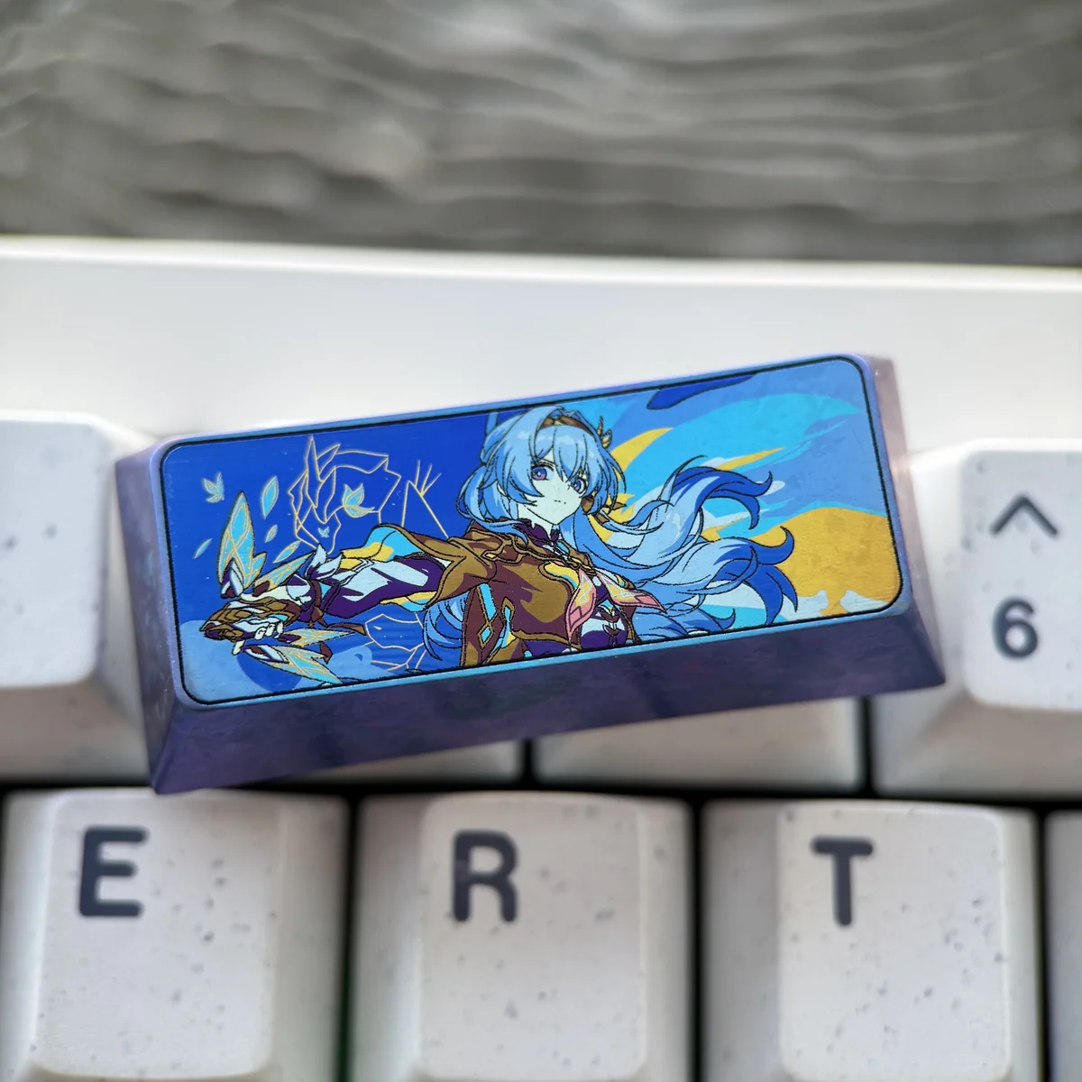 Exclusive Honkai Star Rail Firefly titanium keycap shown from multiple angles, highlighting intricate character art and vibrant metal finish.