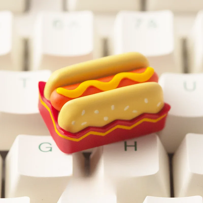 Charming handcrafted hotdog artisan keycap for ESC, revealing its vibrant miniature food art and playful design from an appealing angle.