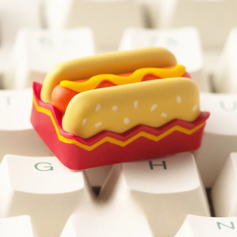 A charming handcrafted hotdog artisan resin keycap for ESC, shown from multiple angles, highlighting its vibrant miniature food art details.