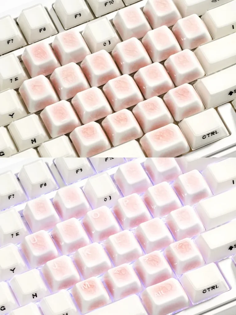 Detailed view of a single pink ceramic heart keycap, showcasing the unique ice crack texture and artisan craftsmanship for mechanical keyboards.