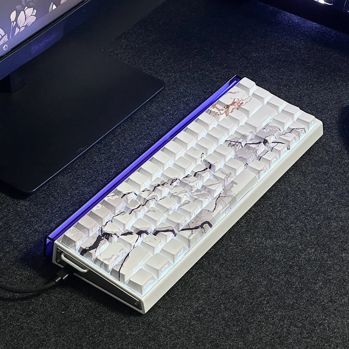 Close-up of premium PBT marble keycaps set, elegantly side-engraved and backlit, showcasing the natural texture and unique glowing legends.