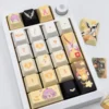 Exquisite Overwatch Mercy artisan keycap set showcasing its angelic white and gold design from multiple elegant angles.