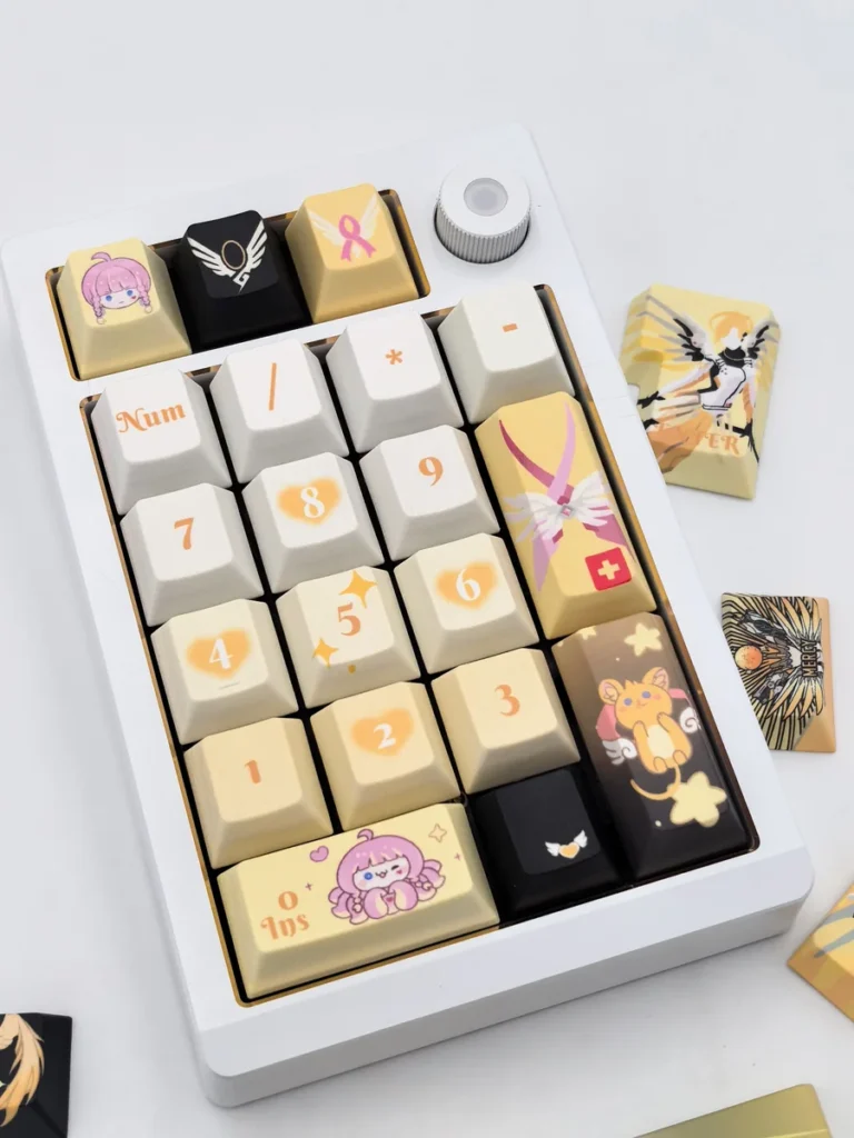 Exquisite Overwatch Mercy artisan keycap set showcasing its angelic white and gold design from multiple elegant angles.