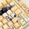 Exquisite Overwatch Mercy artisan keycap set showing its angelic white and gold design from multiple angles, highlighting its detailed craftsmanship.