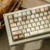 Close-up of Bakehouse Cherry Keycap Set showing unique side-engraved legends and warm toasted hues. Premium artistic design for a minimalist keyboard.