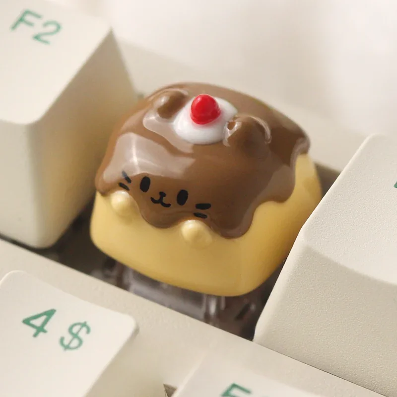 Close-up views of the handcrafted Pudding Cat Keycap, revealing its whimsical resin art, translucent layered design, and adorable 3D feline details.