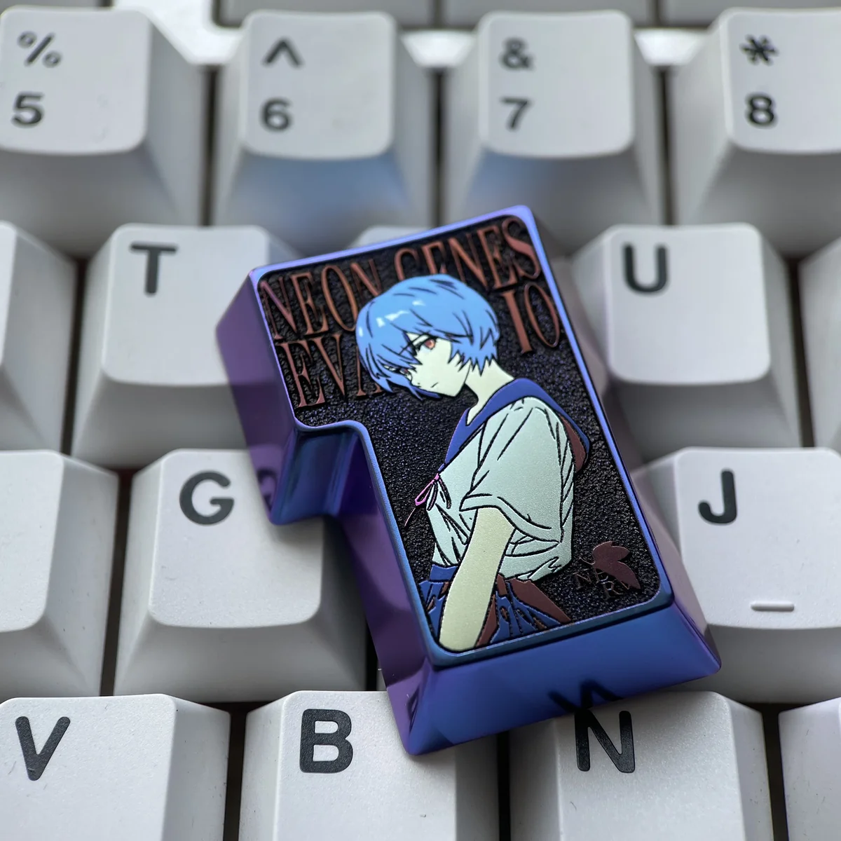 Close-up of the titanium Evangelion keycap, highlighting the intricate artisan craftsmanship.