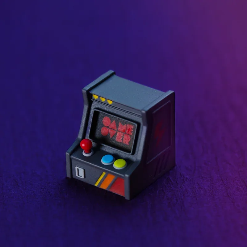 Vibrant handcrafted resin retro game console keycap, showcasing its backlit miniature arcade console design from various angles for the ESC key.