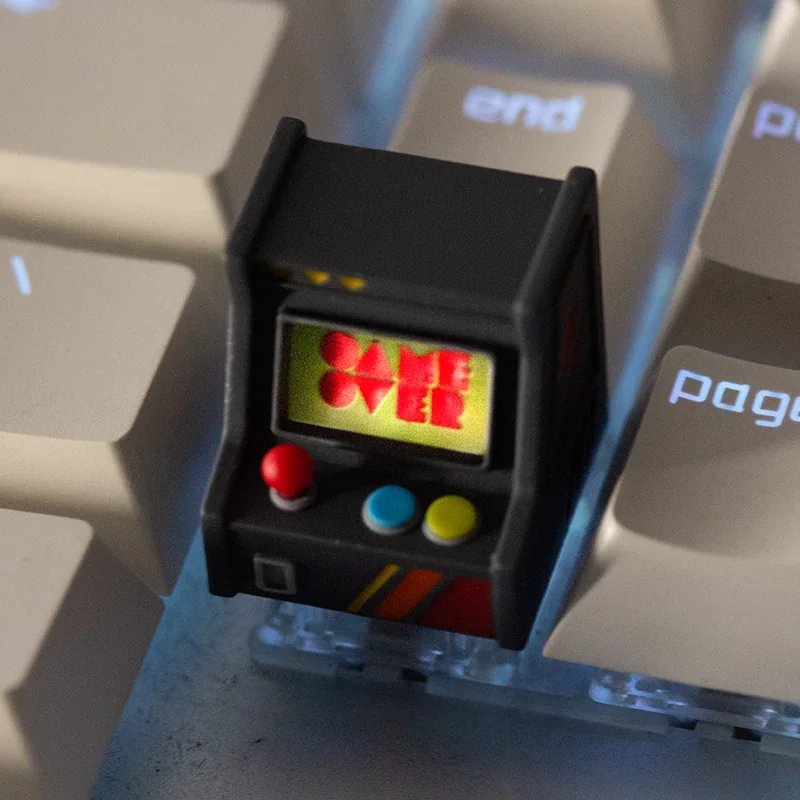 Detailed views of a handcrafted backlit retro game console keycap, showcasing its vibrant resin and miniature arcade ESC design with illuminated details.