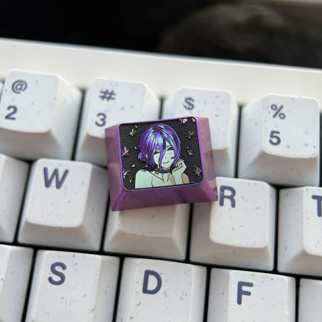 Premium handcrafted Reze titanium artisan keycap, showcasing dynamic Chainsaw Man character design and sleek finish from various perspectives.