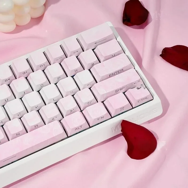 A collection of Rose Coast Luminous Side-Engraved PBT Keycaps, showcasing their serene pink, orange, and grey gradients from multiple artistic angles.