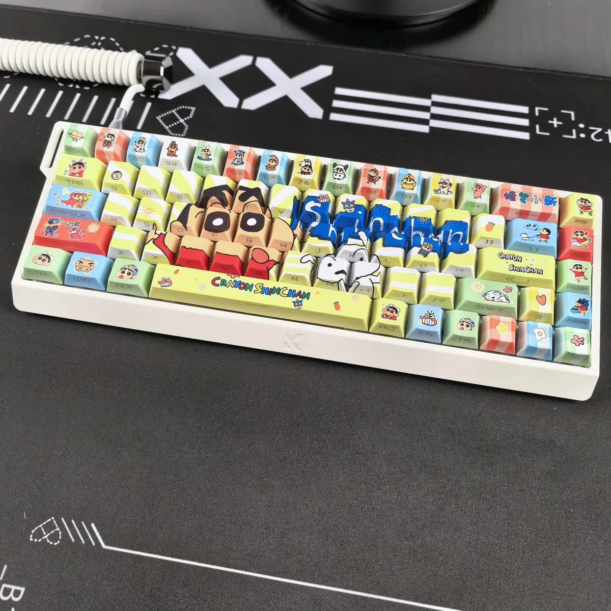 A vibrant gallery showcasing Shin-chan side-print backlit PBT keycaps set from multiple playful angles, highlighting the iconic cartoon characters and glowing design.