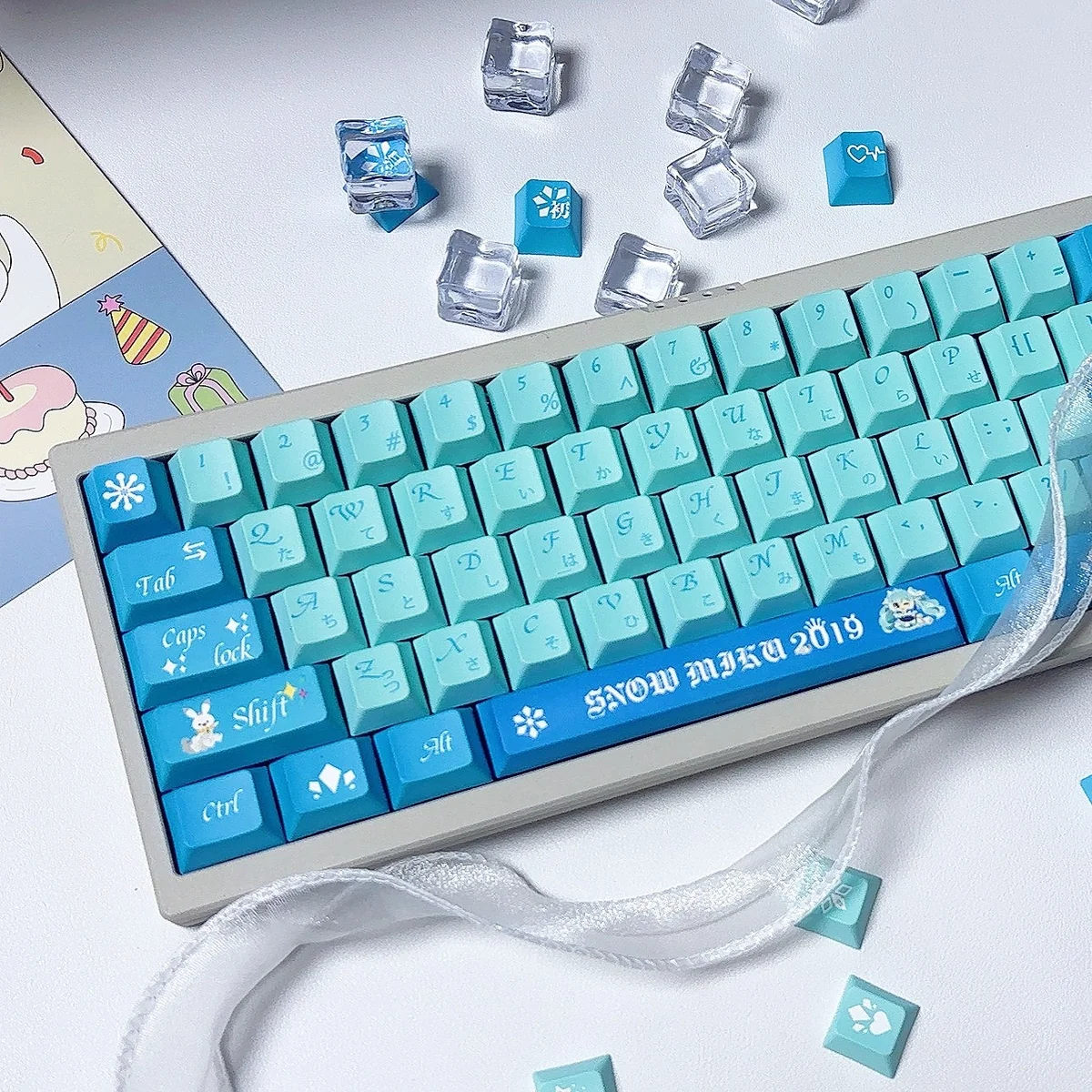 Exclusive Snow Hatsune Miku PBT dye-sub keycap Set, Winter Dream. Icy blue, white, purple Snow Miku art and snowflakes shown from multiple angles.