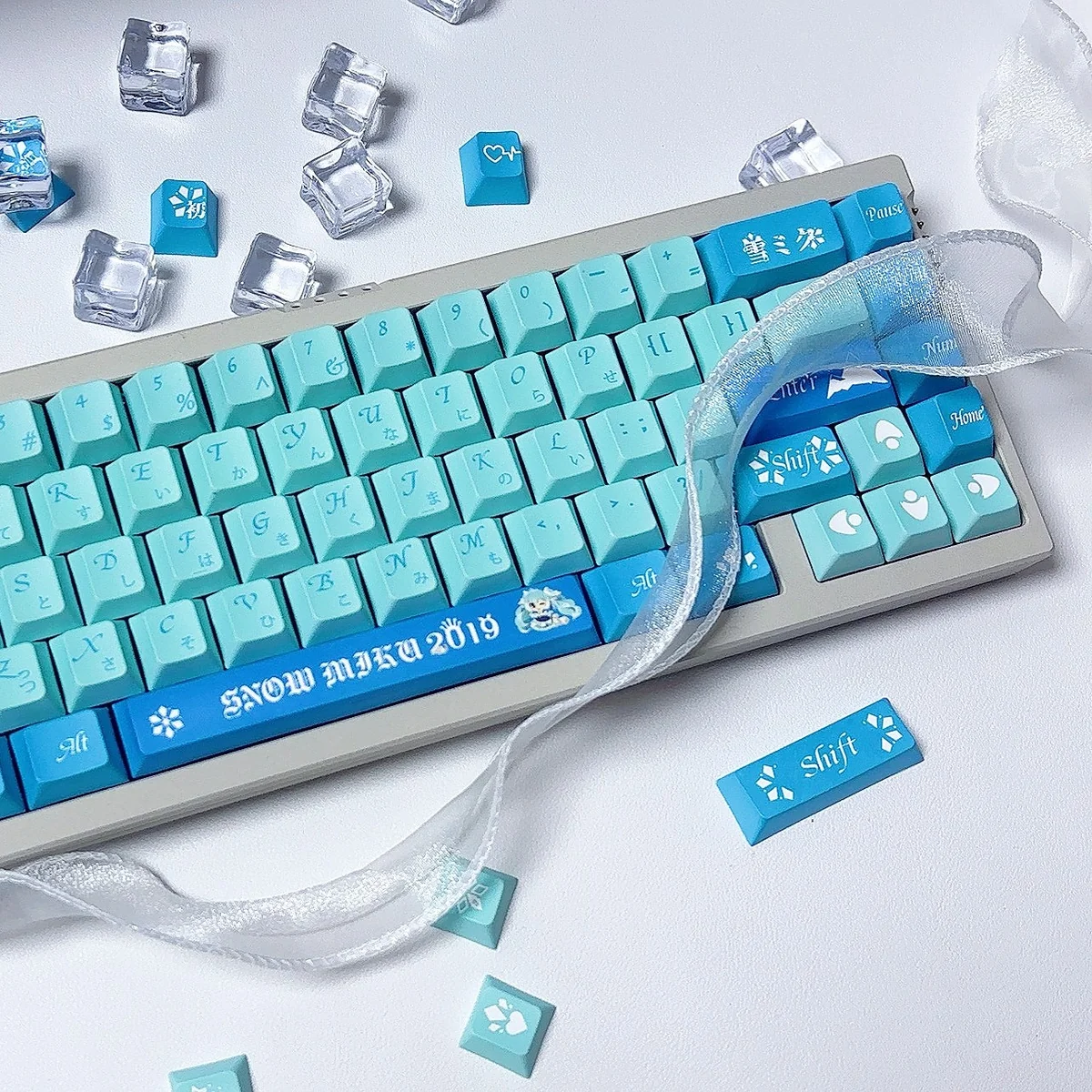 Exclusive Snow Hatsune Miku PBT Dye-Sub keycaps Set with intricate icy blue, white, and purple Snow Miku art and snowflakes, seen from multiple angles.
