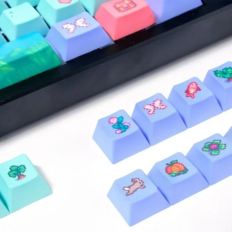 Angled view of the immersive Stardew Valley PBT dye-sub keycap set, displaying vibrant pixel art farm elements and earthy tones.