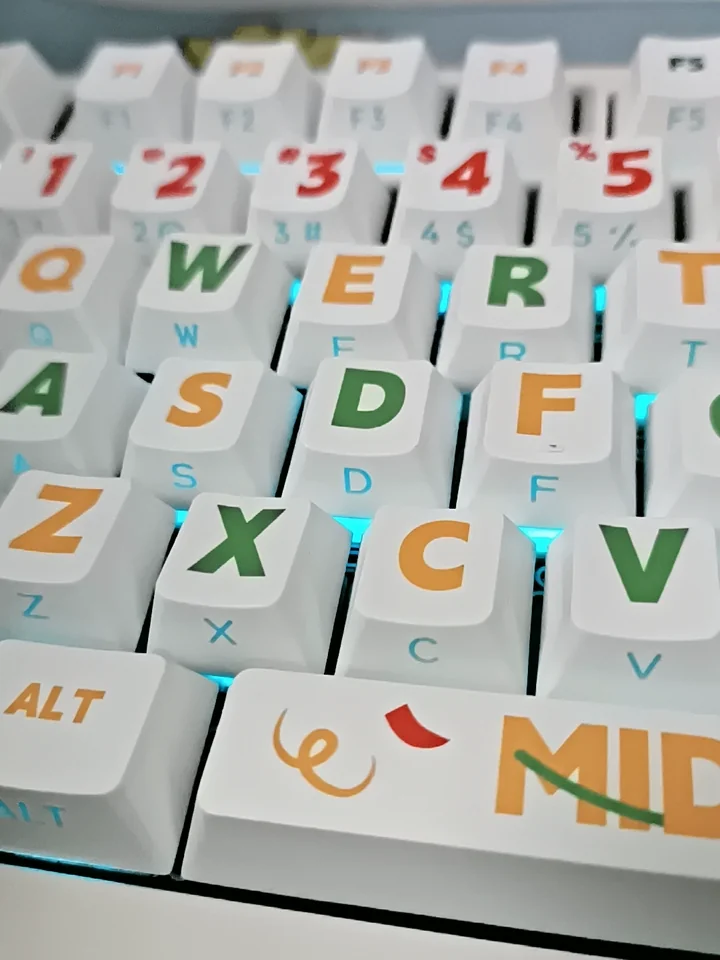 Close-up of vibrant Summer Party PBT keycaps set, showcasing playful side-printed, translucent legends in Cherry profile for a backlit keyboard.