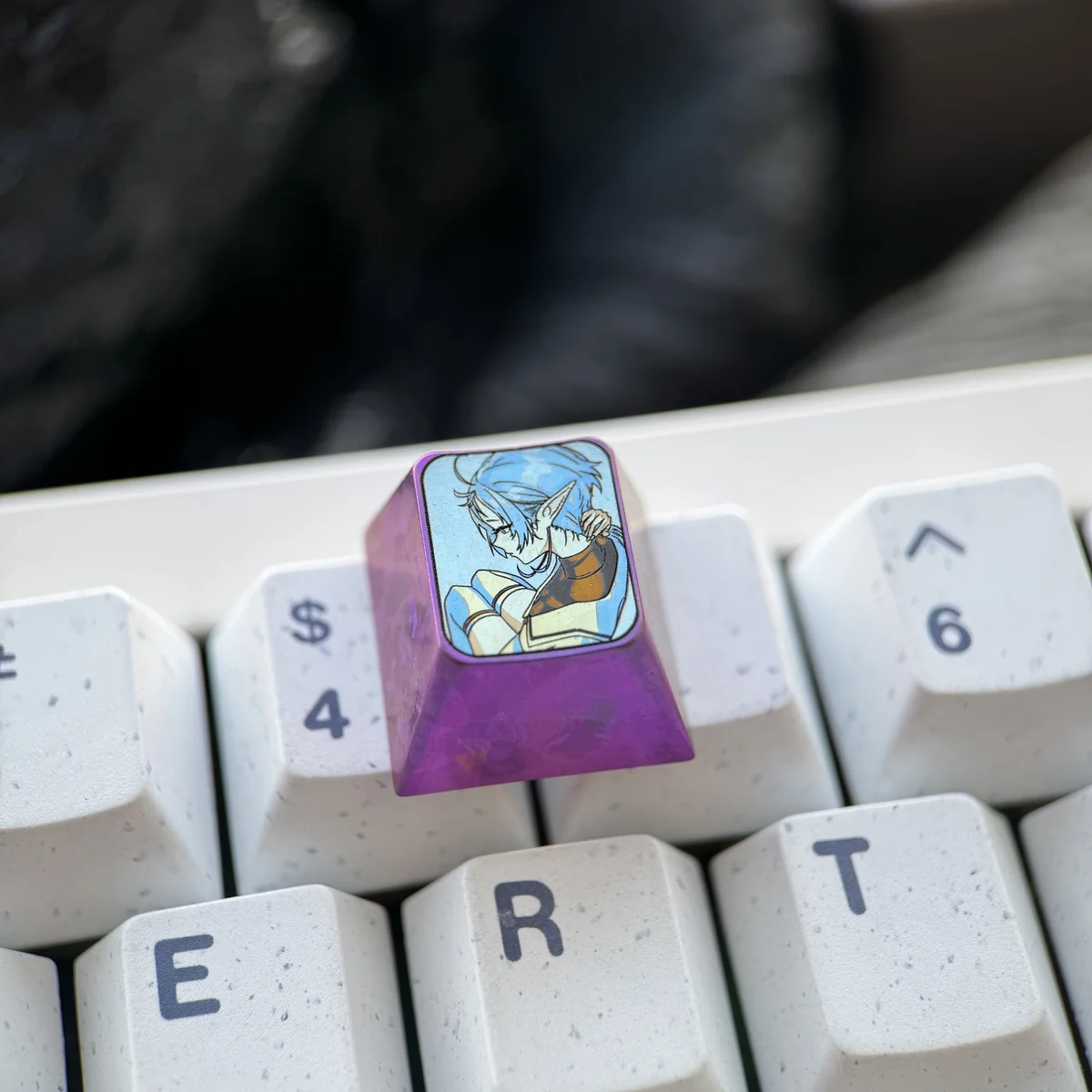 Premium titanium Sylphiette artisan keycap for ESC, viewed from multiple angles, highlighting vibrant anime character art on polished alloy.