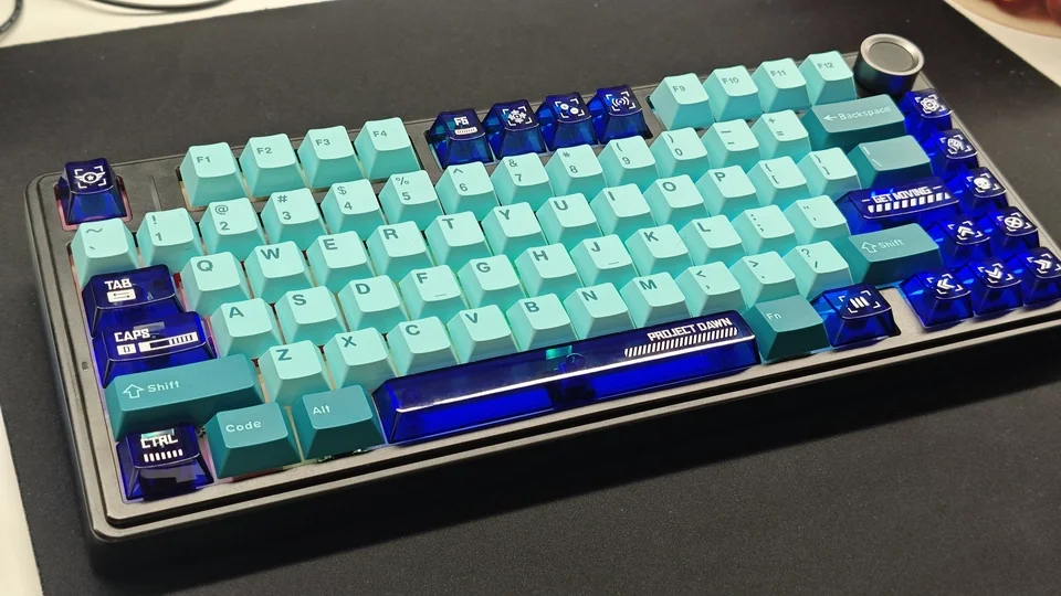 Vibrant transparent blue PC Supplement Keycap Set with an ethereal Dawn gradient, enhancing custom keyboards with artistic, luminous aesthetics.
