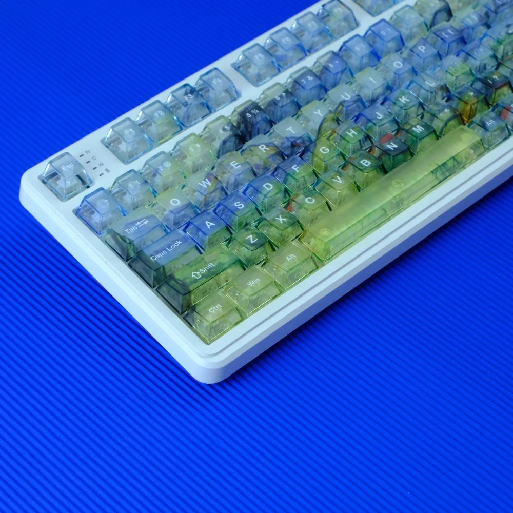 Van Gogh inspired misty translucent PC keycaps set, beautifully illuminated, revealing their frosted artistry and dreamlike diffused glow from various angles.