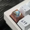 Close-up of custom titanium keyboard accent for Wuthering Waves fans, detailing craftsmanship.