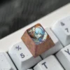 Handcrafted titanium gaming accessory with Wuthering Waves Camellya motif, showing its lustrous detail.