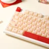 Gallery views of the playful Yakult artisan keycap set, showing its whimsical warm red beige bottle design from various angles. Nostalgic desk art.