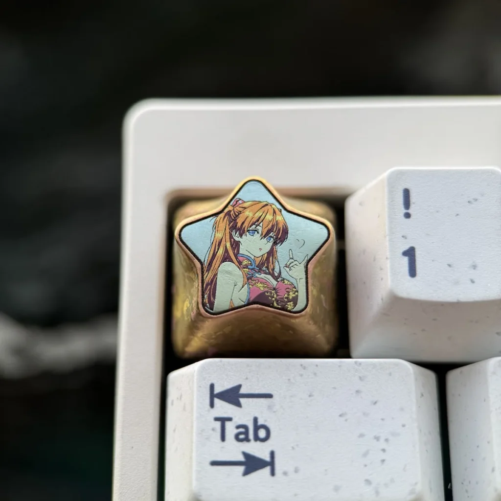 Asuka Langley Soryu titanium artisan keycap featuring a star design on a mechanical keyboard