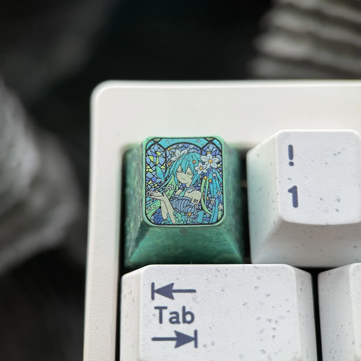 Detailed shot of the 'Broken Glass' texture on the Hatsune Miku titanium keycap
