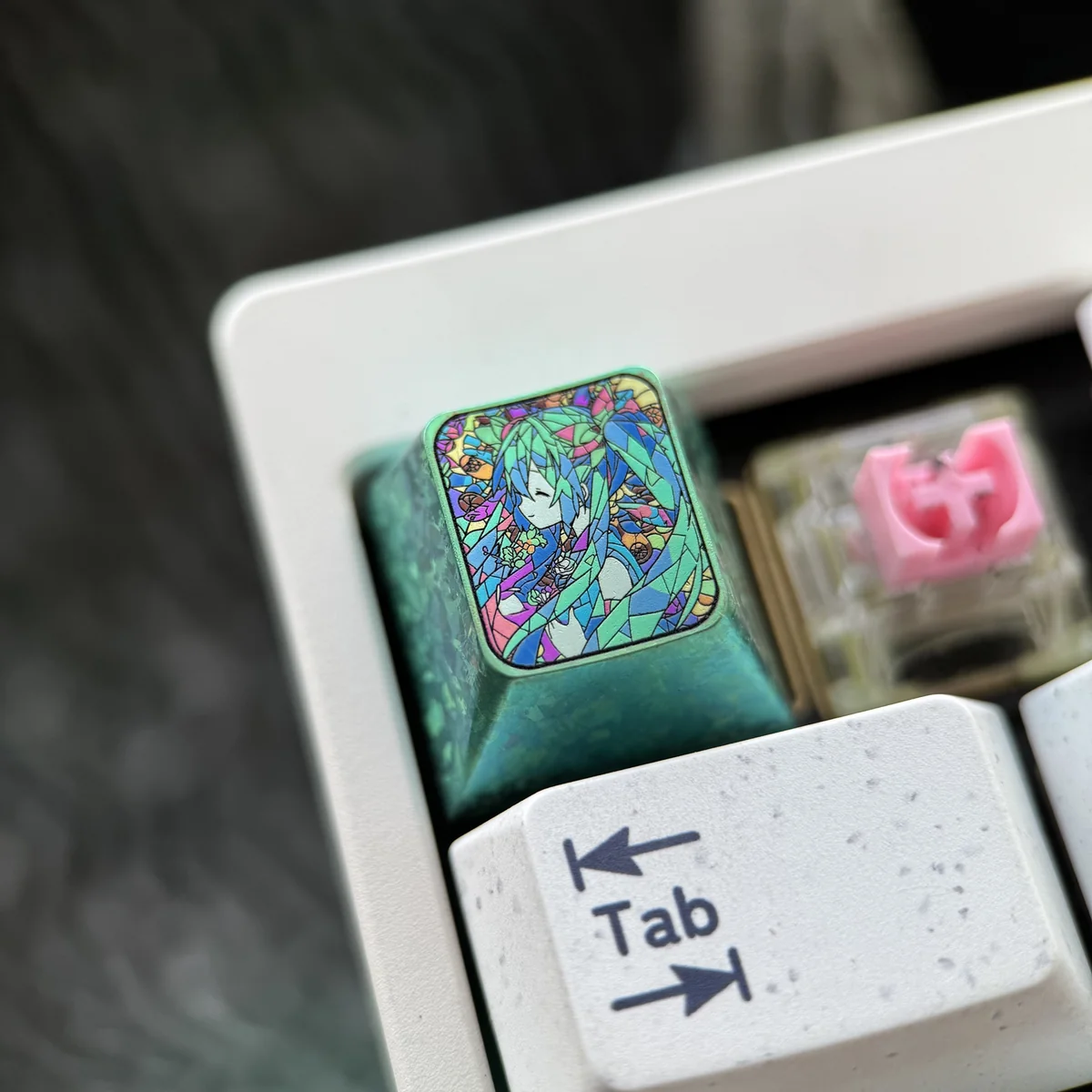 Collection of Hatsune Miku keycaps, emphasizing the unique broken glass design on each