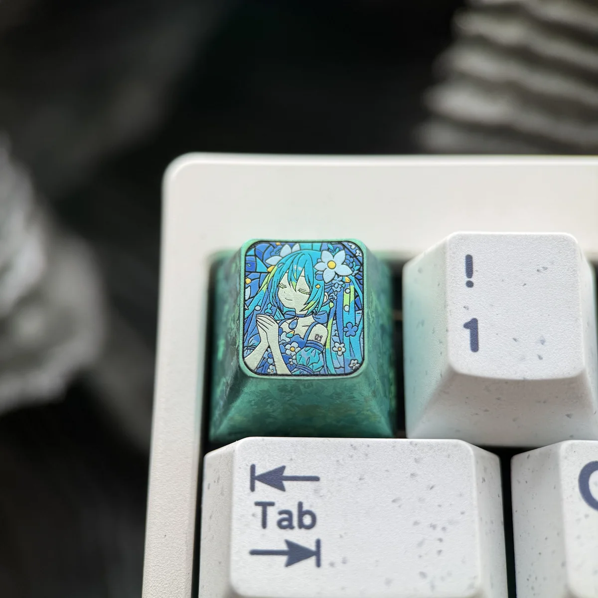 Hatsune Miku keycap from an angle, revealing its ergonomic shape and material quality