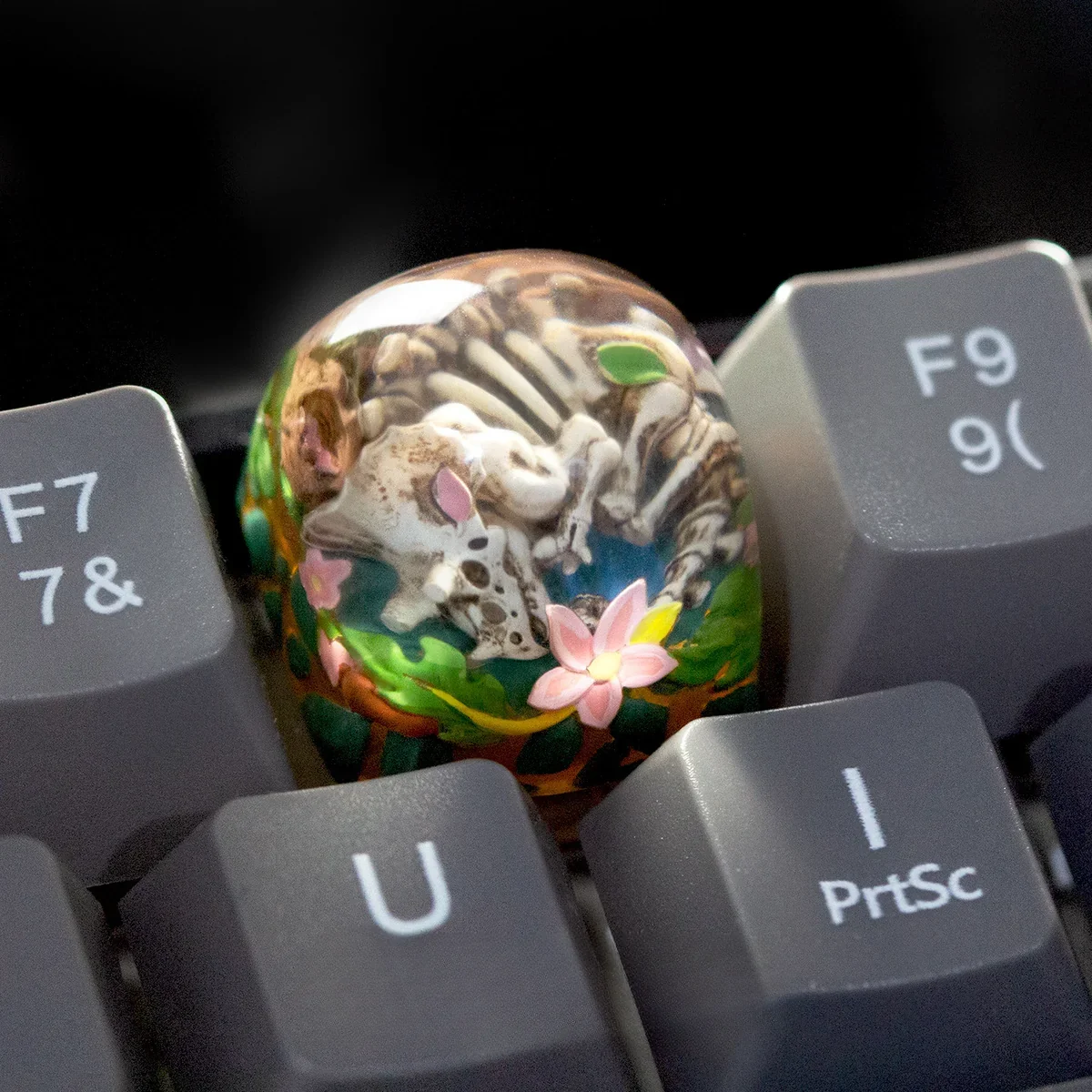 Handcrafted Triceratops keycap, close-up, backlit glow on keyboard