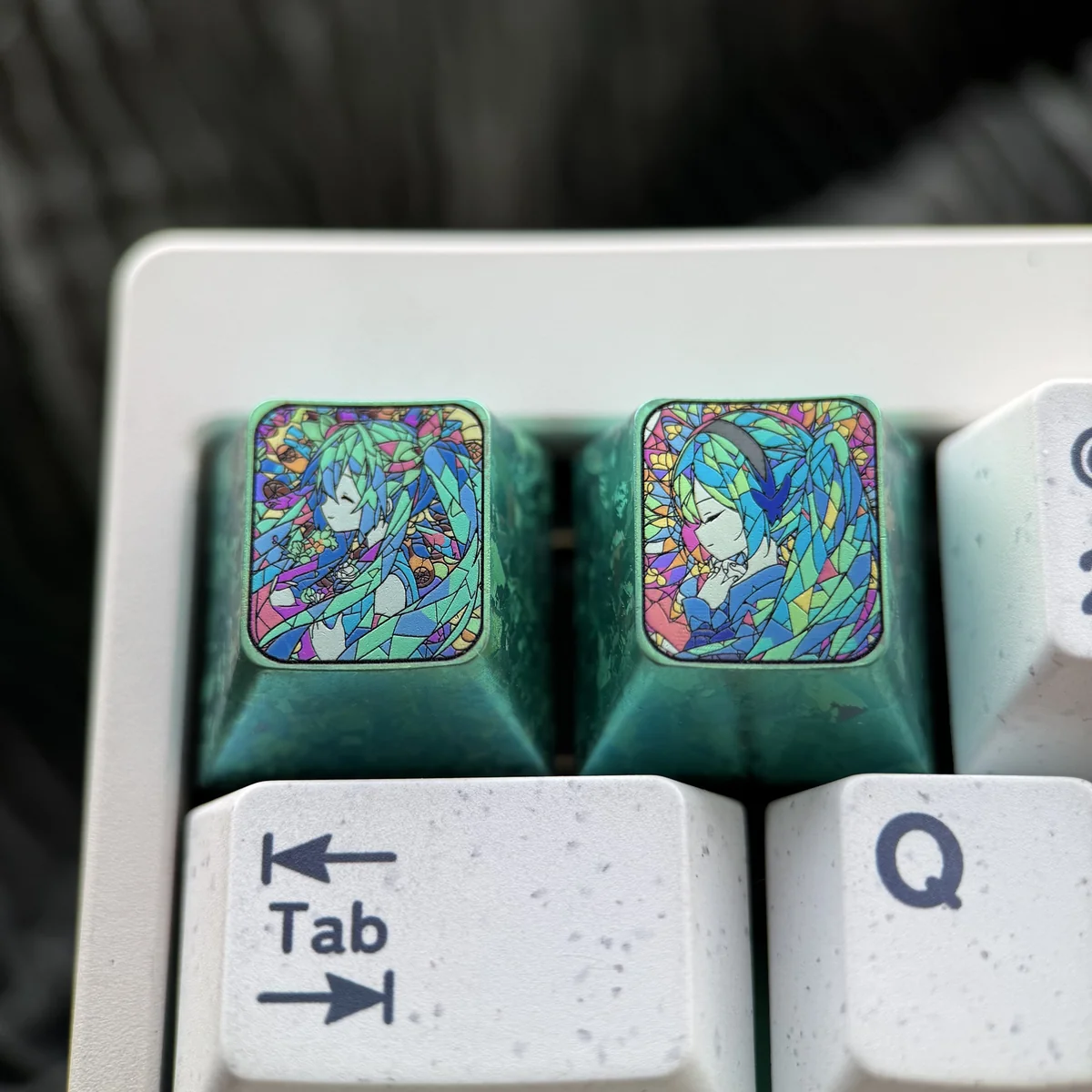 Close-up of Hatsune Miku keycap showing vibrant broken glass details and titanium luster