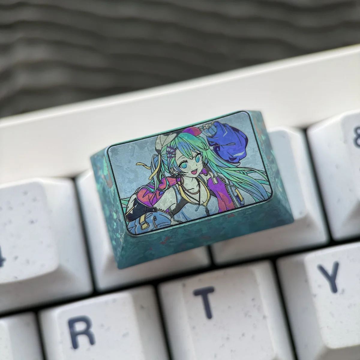 Detail of Hatsune Miku design engraved on titanium keycap