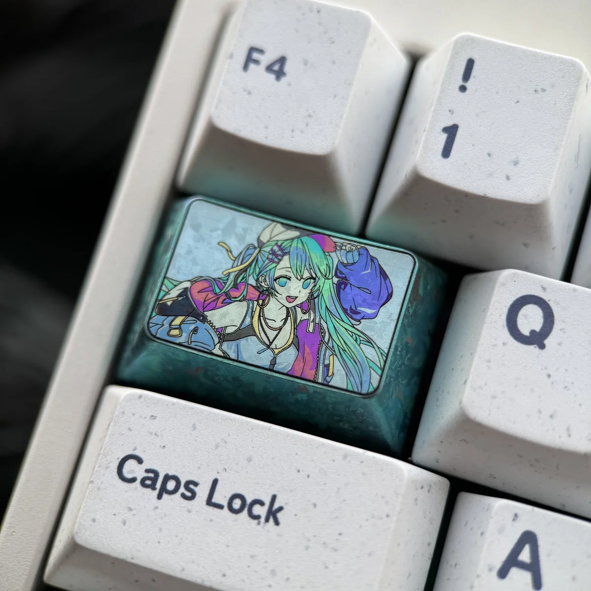 Close-up of Hatsune Miku keycap showing titanium texture