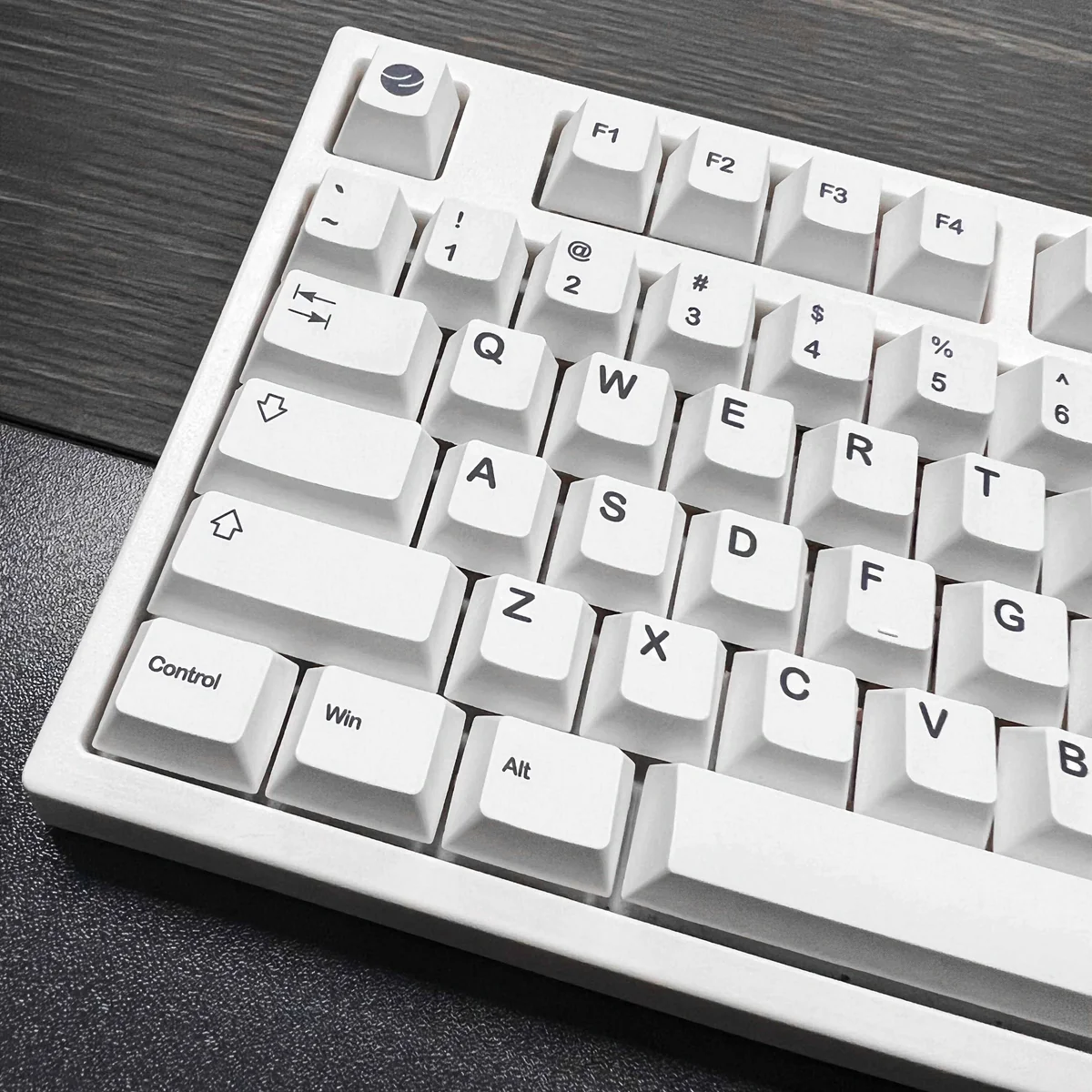 Monochromatic Cosmic keycaps installed on a black mechanical keyboard