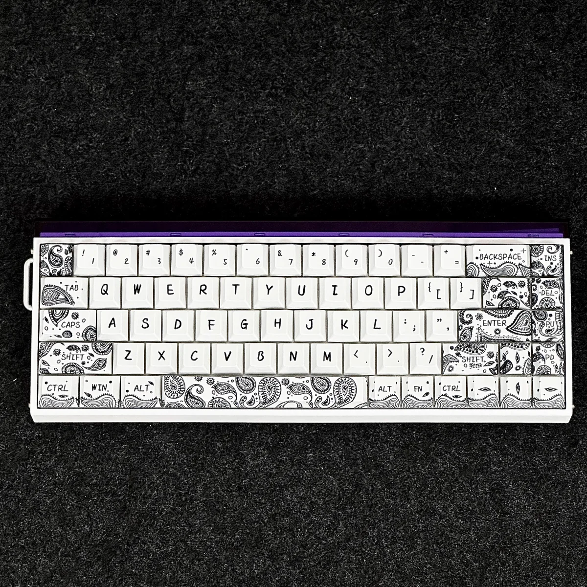 Arrangement of individual Paisley PBT keycaps, showing various key sizes and the consistent design.