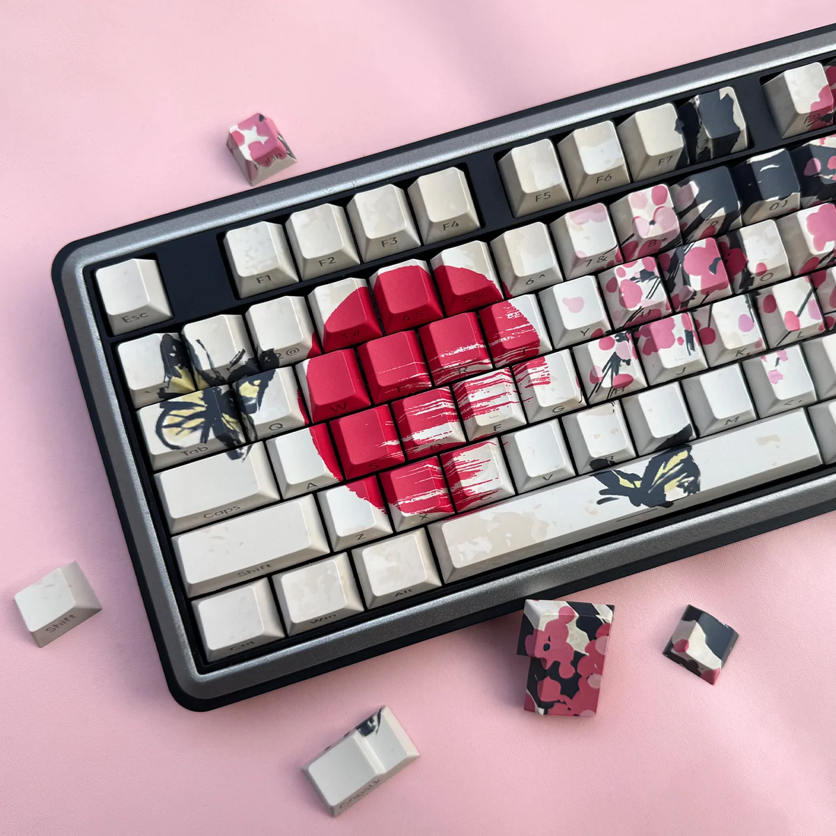 Close-up of side-lit plum blossom legends on PBT keycaps