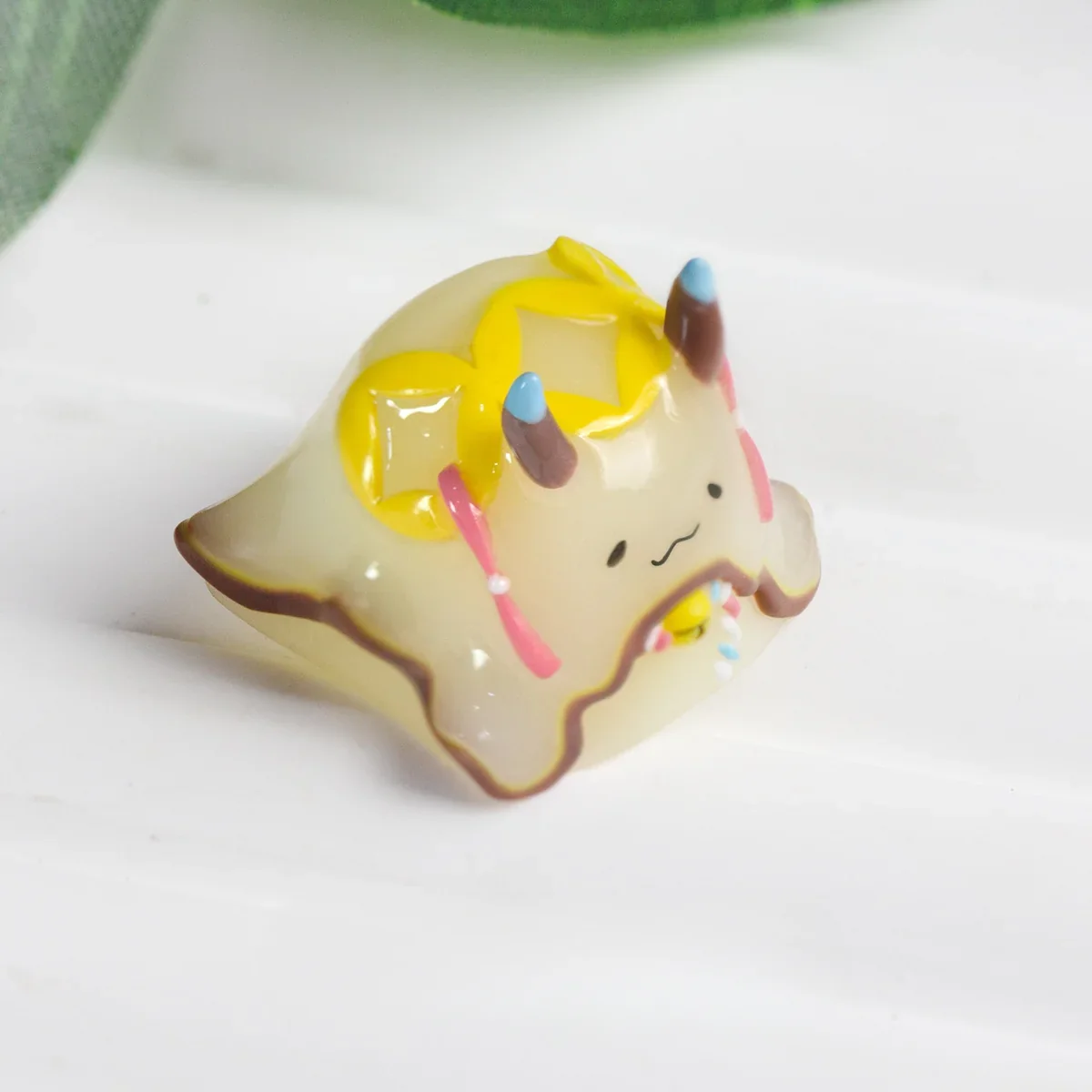 Overhead shot of the whimsical Sea Hare Artisan Keycap's intricate marine design