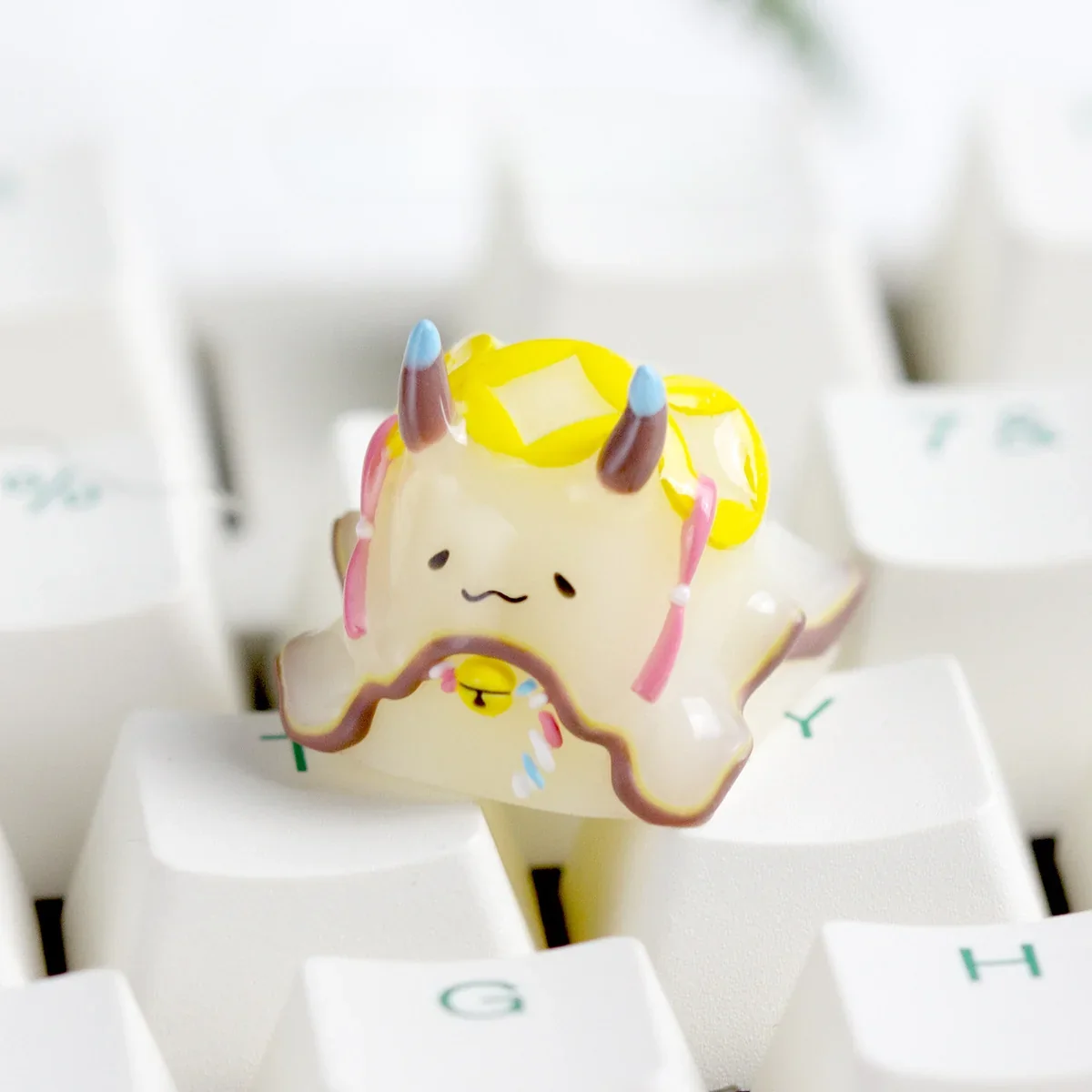 Detailed close-up of a handcrafted resin Sea Hare keycap showing translucent body