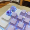 Hand holding a Crushed Ice Keycap, showcasing its artisanal craftsmanship and unique design.