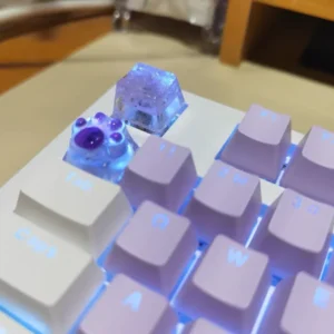 Hand holding a Crushed Ice Keycap, showcasing its artisanal craftsmanship and unique design.