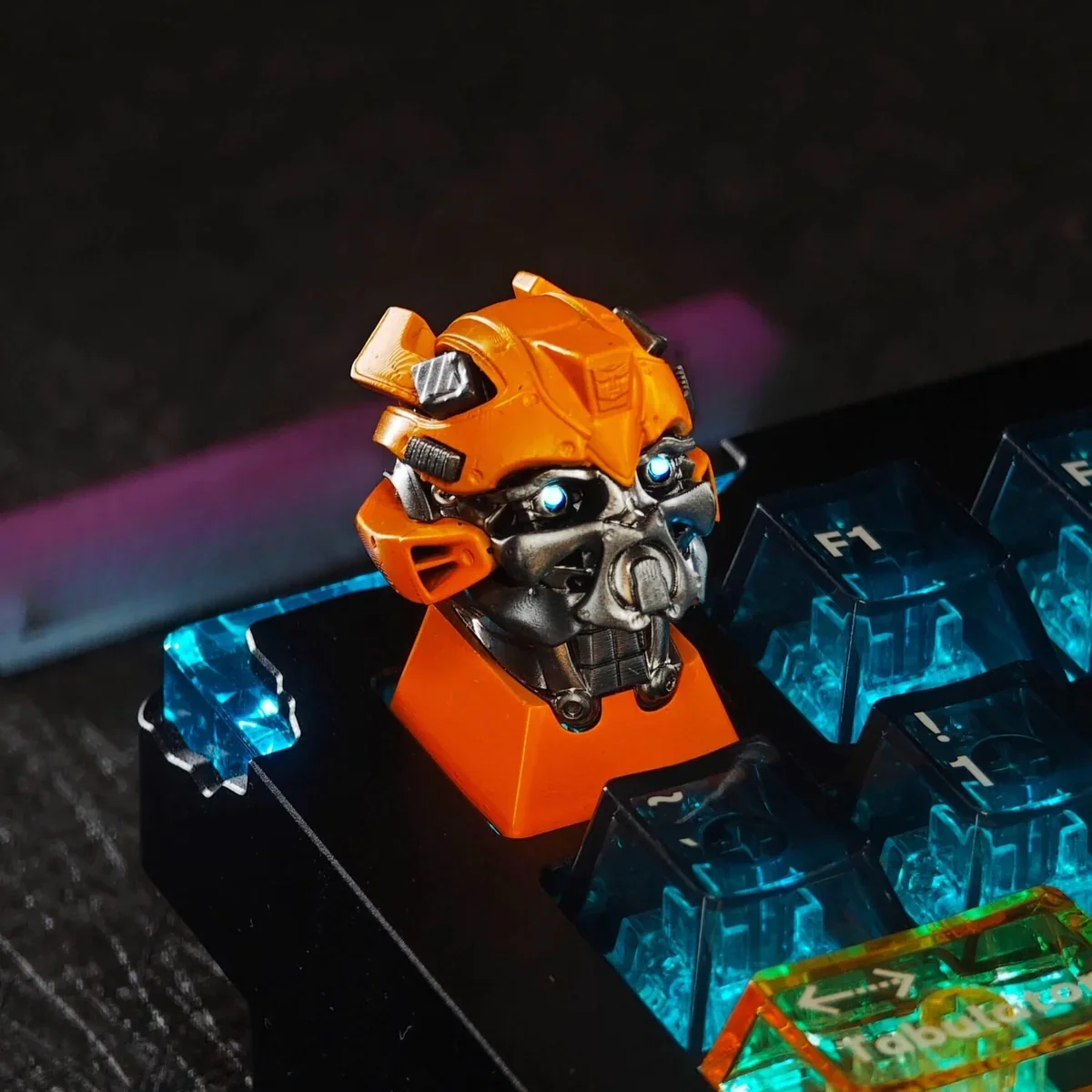 Close-up of backlit Bumblebee resin keycap with RGB lighting