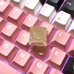 A backlit Crushed Ice Strawberry Keycap glowing on a keyboard, highlighting its translucent properties.