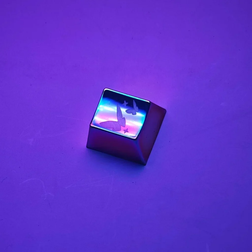 Side view of a metal artisan keycap showcasing Cherry profile and detailed butterfly design