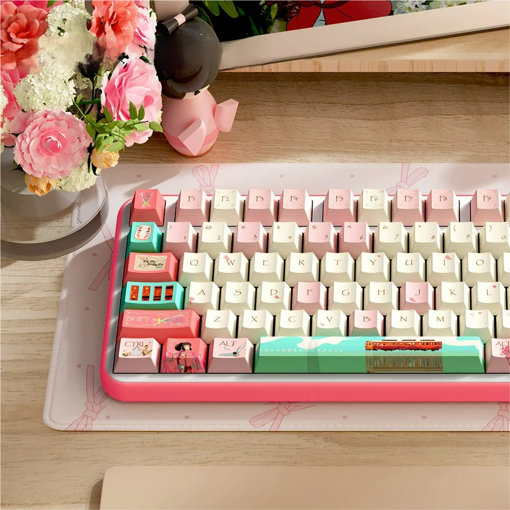 Detailed shot of individual Spirited Away keycaps, showing the vibrant dye-sublimated legends and PBT texture